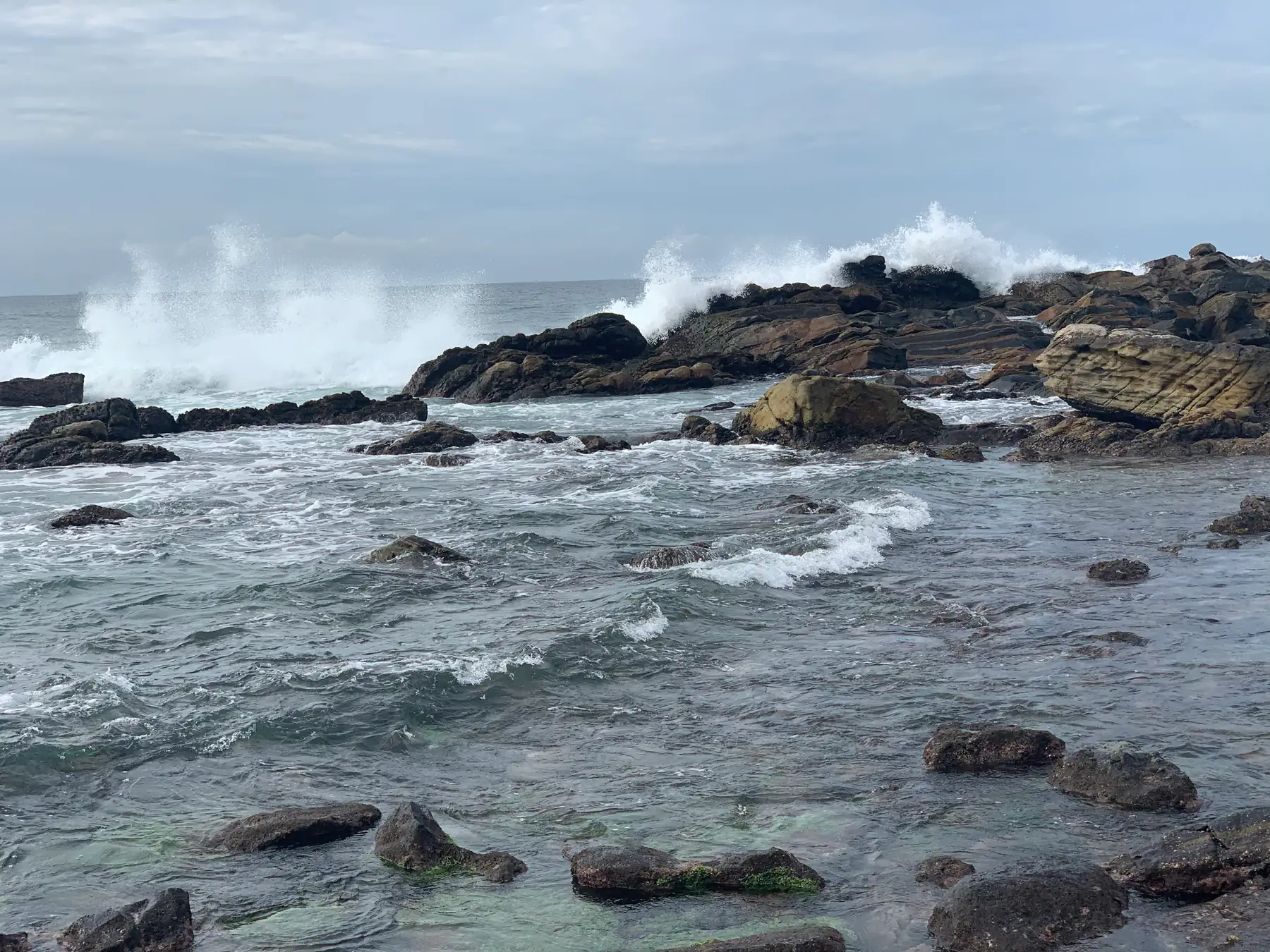 Rocky shore at Dickwella beach on a windy afternoon.