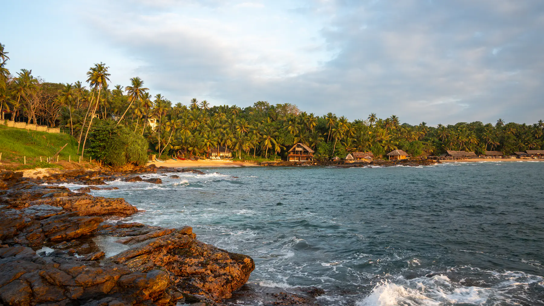 Goyambokka Beach, Tangalle, with rocks and palms.