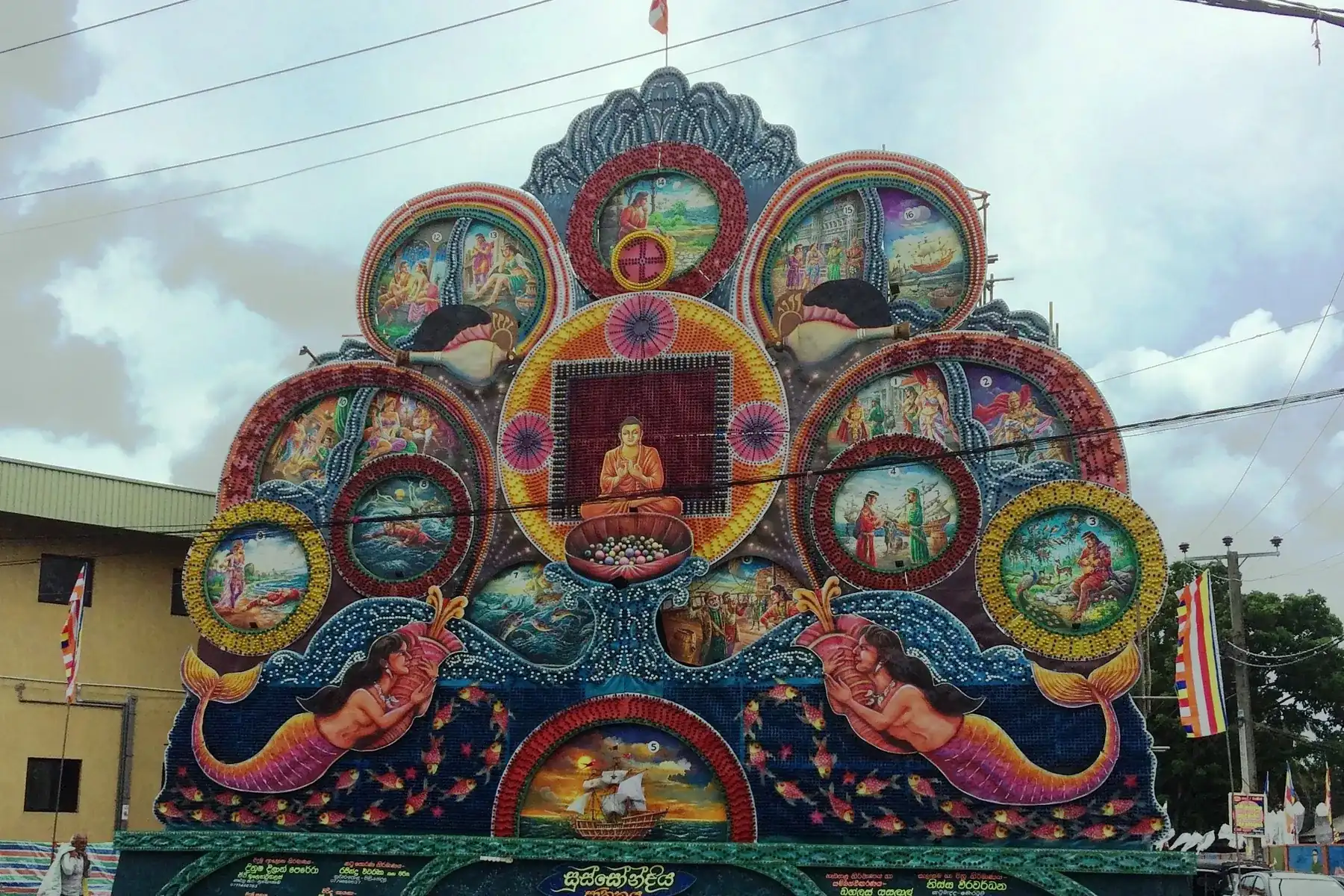 A colourful Vesak pandol with painted Buddhist story panels at Piliyandala.