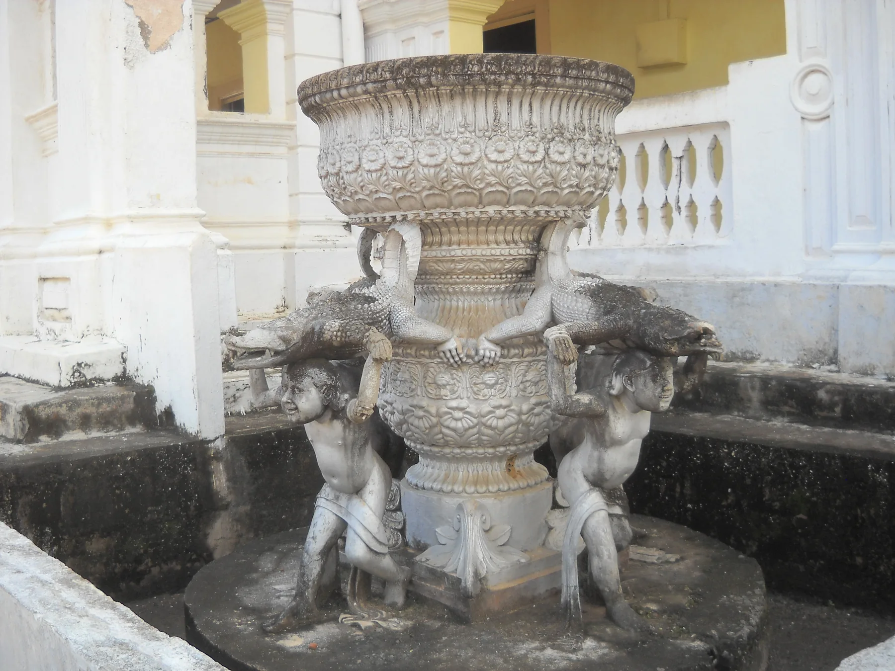 A decorated urn and fountain with carved figures in the grounds of Wewurukannala Vihara near Dickwella.