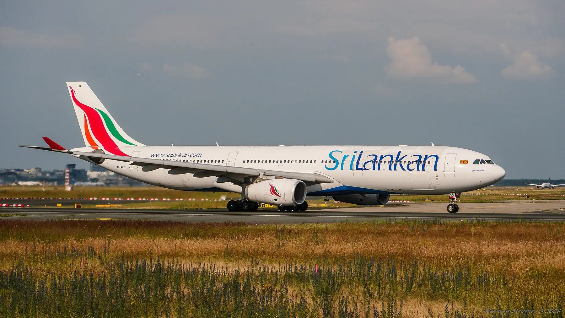 A SriLankan Airlines Airbus A330 taxiing on a runway.